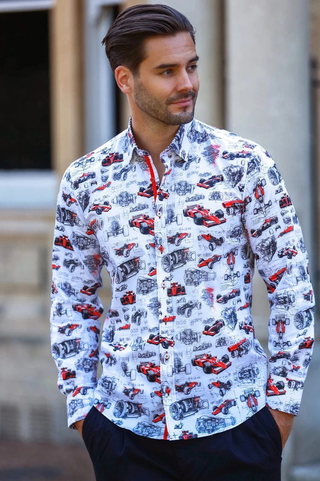 Man wearing a Claudio Lugli pit lane F1 shirt with Formula one car pattern standing outdoors.