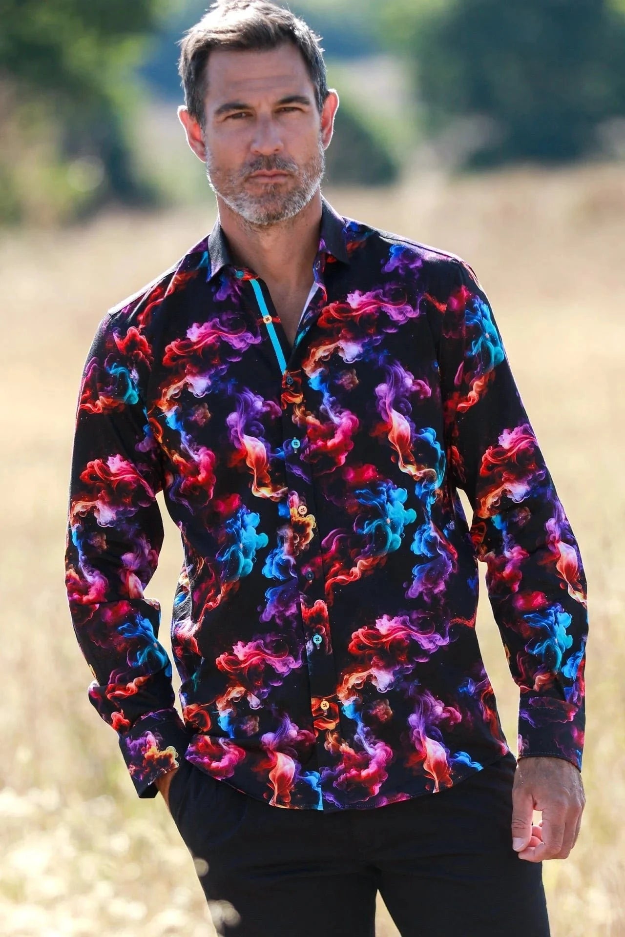 Man wearing a colorful Claudio Lugli shirt with horse pattern outdoors