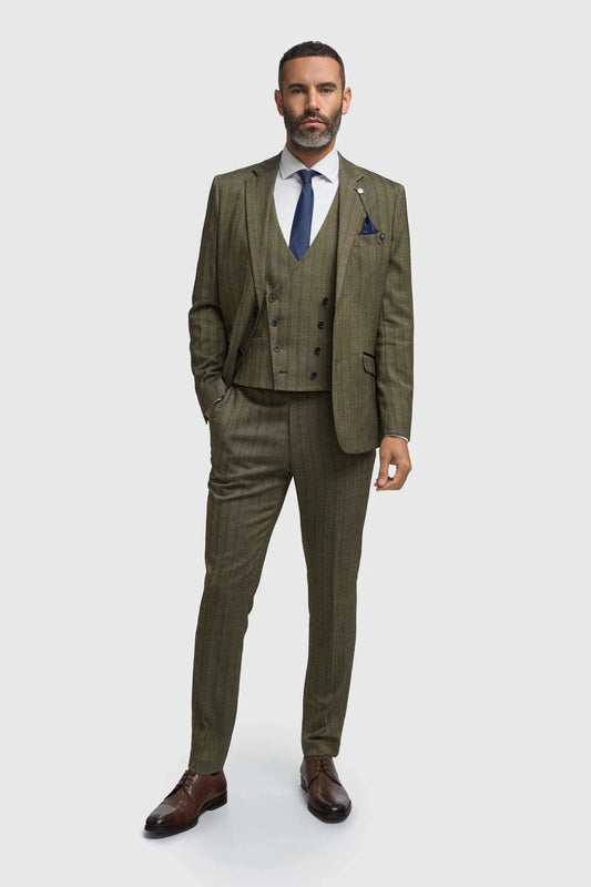 Man wearing a Cavani Damon Sage Tweed suit with a white shirt and blue tie on a white background