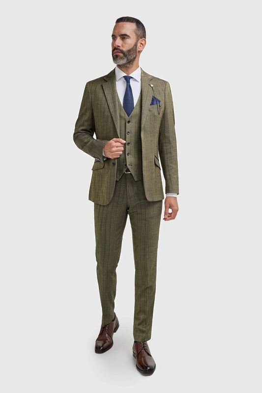 Man wearing a Cavani Damon sage tweed suit with a blue tie and pocket square on a white background