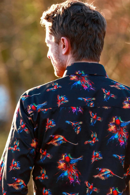 Man wearing a dark Claudio Lugli  shirt with watercolour pheasant pattern outdoors