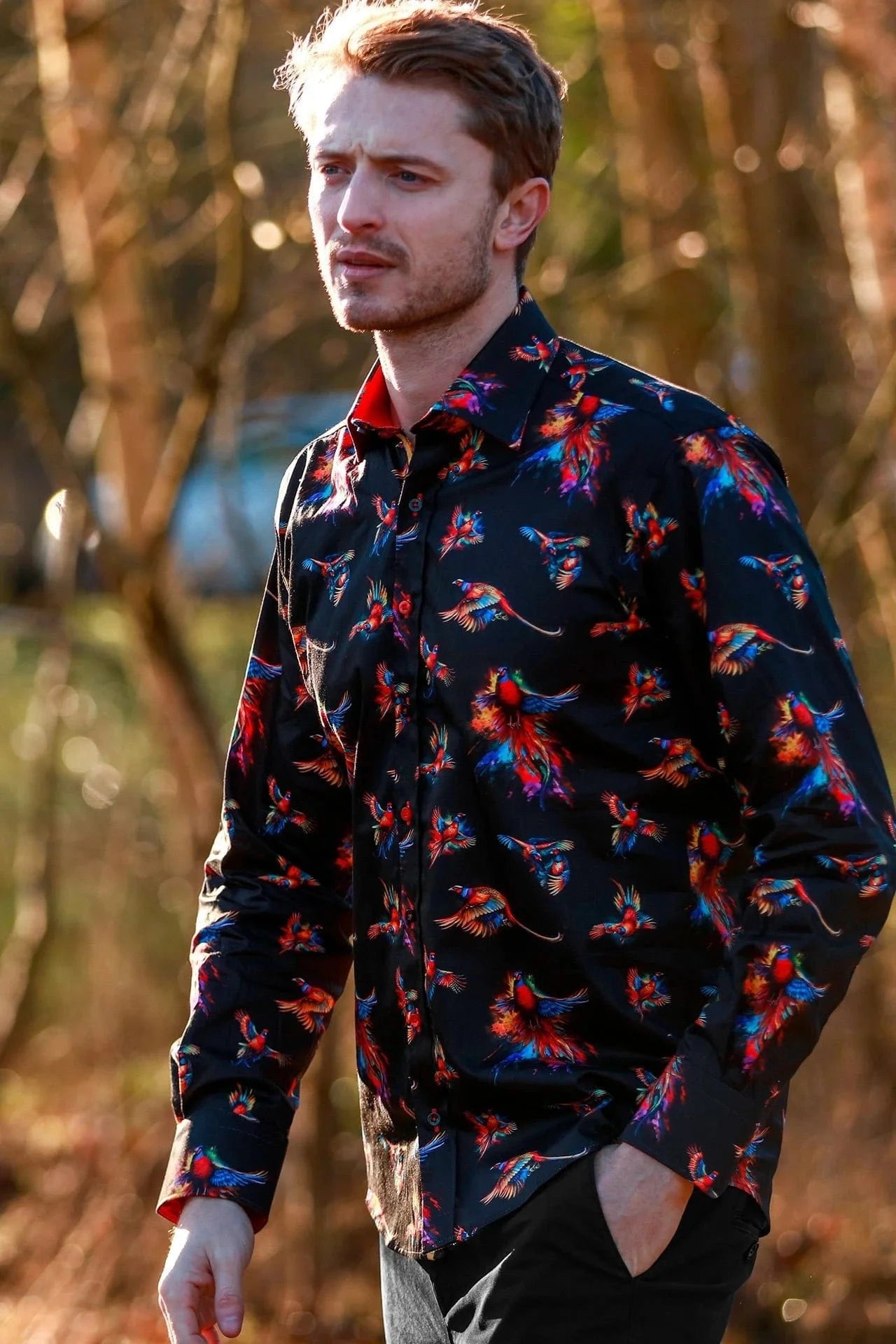 Man wearing a dark Claudio Lugli  shirt with watercolour pheasant pattern outdoors