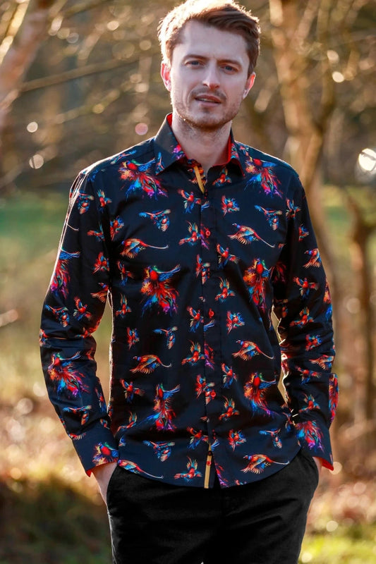 Man wearing a dark Claudio Lugli  shirt with watercolour pheasant pattern outdoors